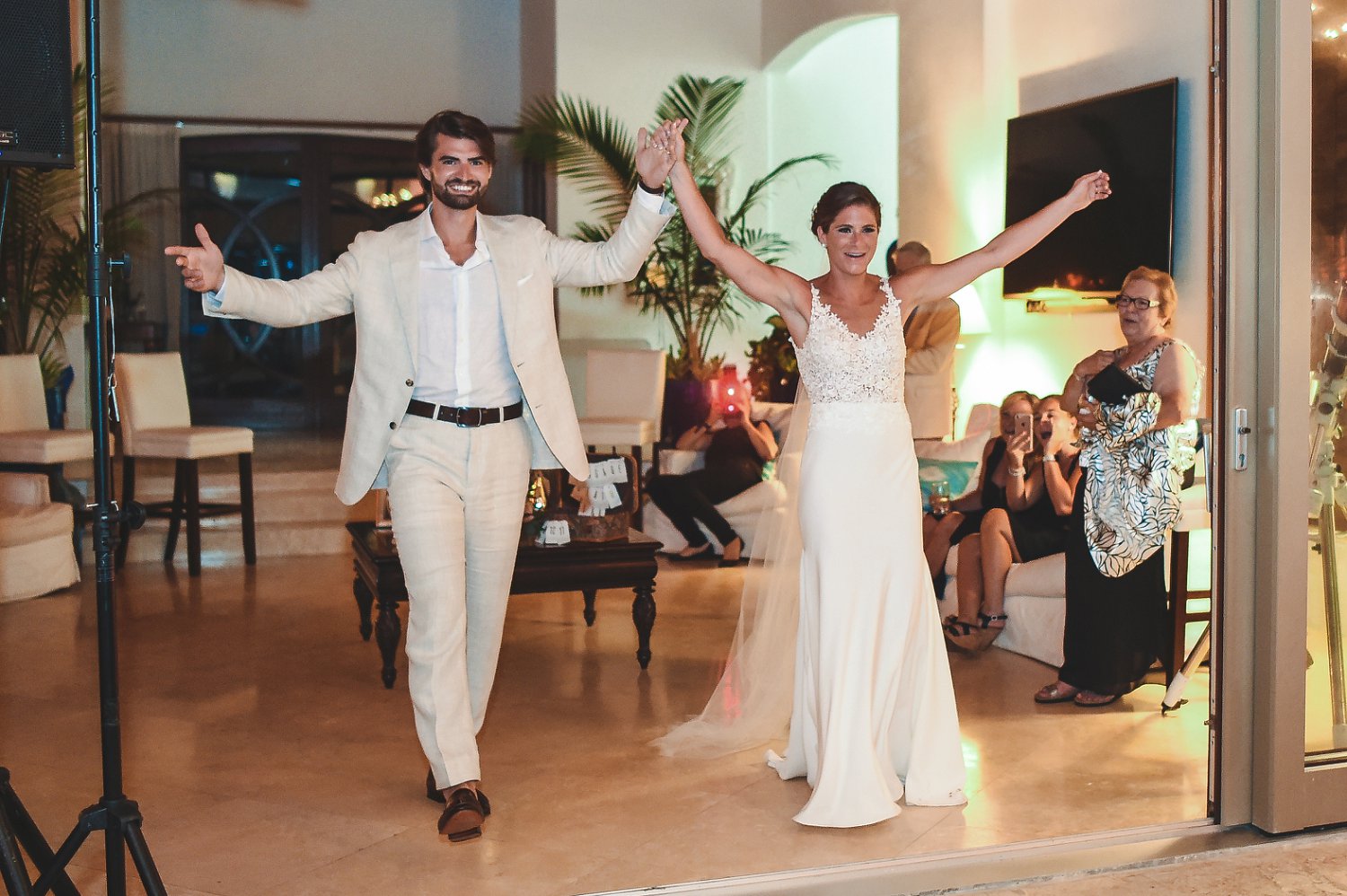Just married couple walks into wedding reception for first dance.