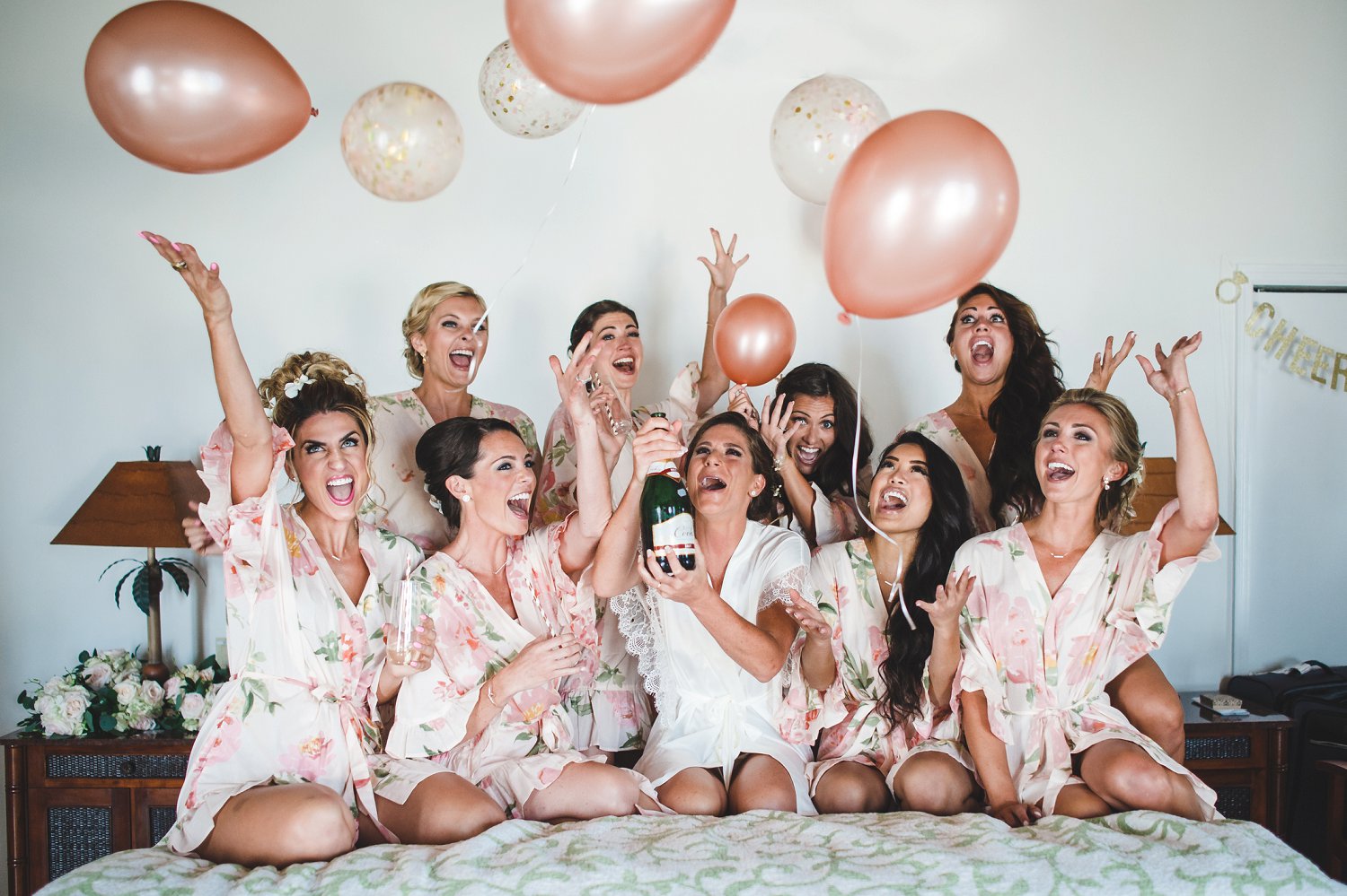 Must have bride and bridesmaids getting ready photo with champagne, balloons and matching robes.