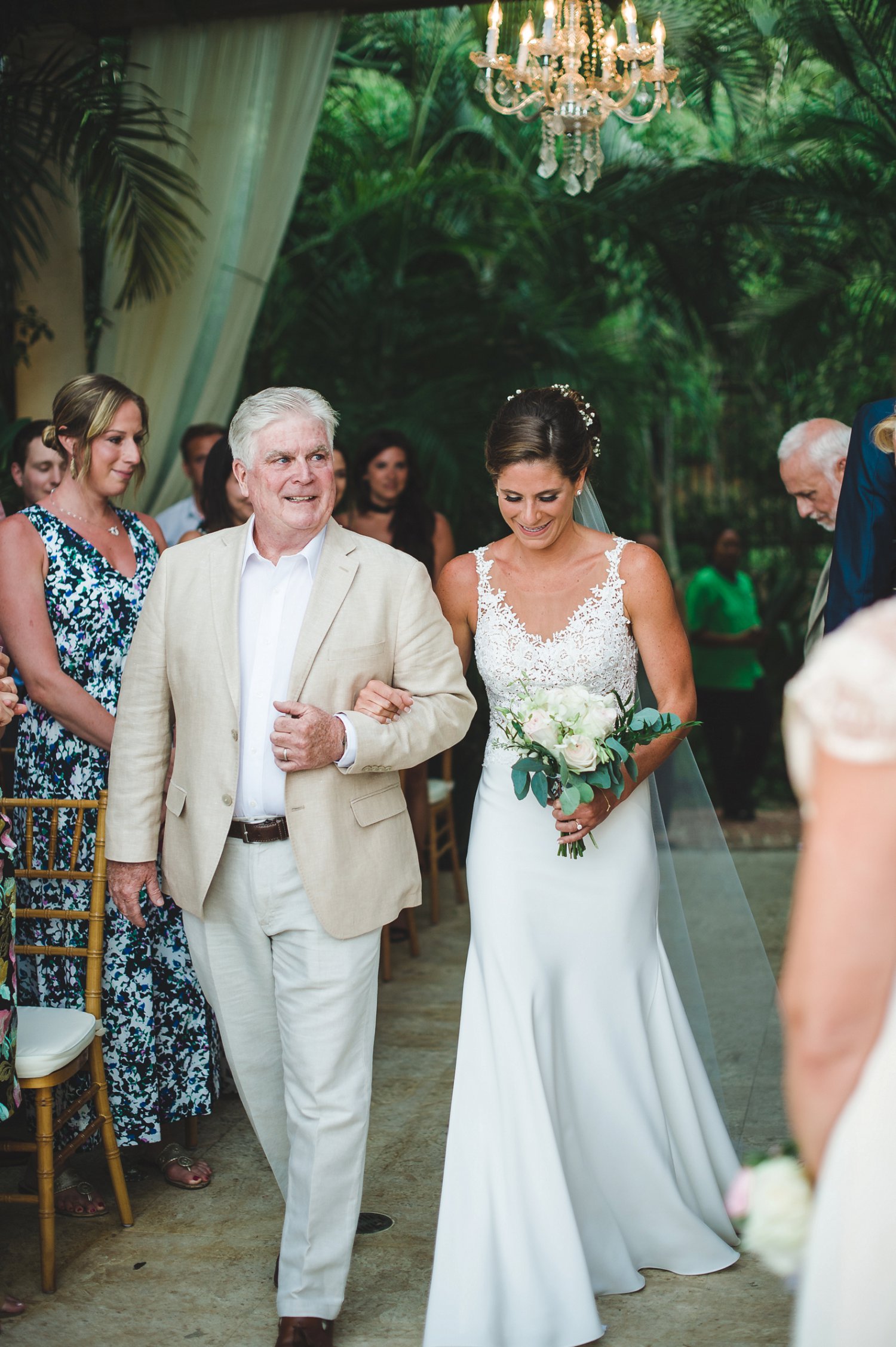 Bride and her father walk down the aisle at wedding ceremony at Villa Serenita.
