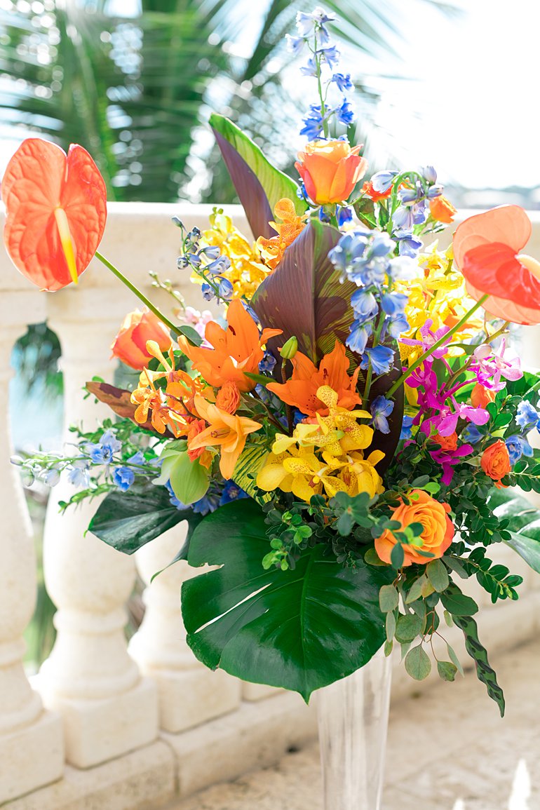 Large floral arrangements with tropical flowers and tropical colors including anthuriums for destination wedding