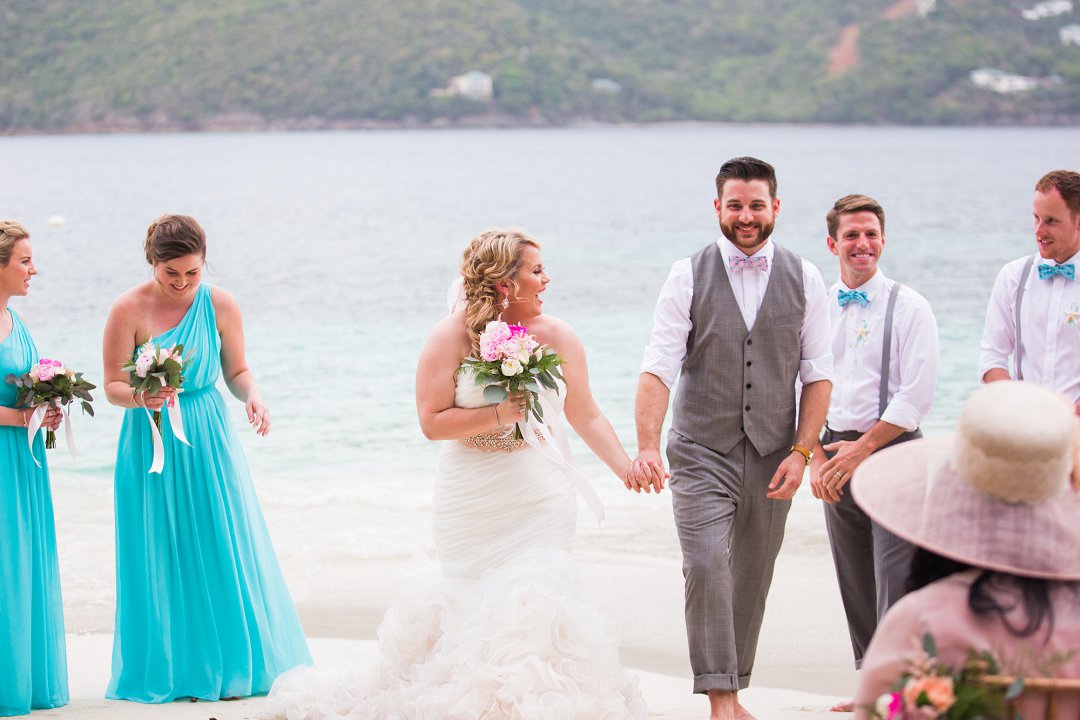 Bride and groom walking down the aisle after beach wedding ceremony at Sand Dollar Estate in St. Thomas